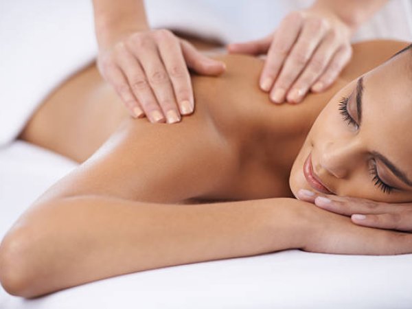 Therapist performing a back massage